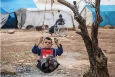  ?? Picture: EPA-EFE ?? IN THE BALANCE: A displaced child rides an improvised swing in the Atamah camp at the Syrian-Turkish broader in Idlib, Syria.