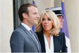  ??  ?? PARIS: In this July 20, 2017 file photo, French President Emmanuel Macron, left, and his wife Brigitte Macron await for a dinner at the Elysee Palace. — AP