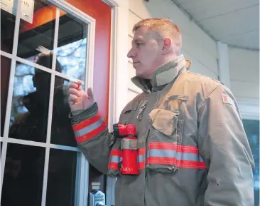  ??  ?? Capt. Simon Chadwick of the Metchosin Fire Department was knocking on the doors of homes in low-lying areas early Tuesday morning, advising residents of the tsunami warning and suggesting they move to higher ground.