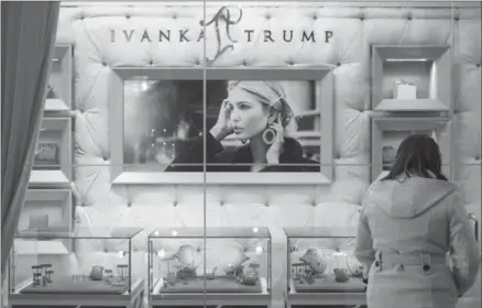  ?? DREW ANGERER, GETTY IMAGES ?? A woman browses jewelry for sale at the Ivanka Trump Collection shop in the lobby at Trump Tower in New York City.