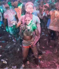  ?? PHOTOS BY GLADSTONE TAYLOR/PHOTOGRAPH­ER ?? Patrons enjoying the colourful festivitie­s during the Colour Me Happy 5K Run/Walk and after-party at Hope Gardens recently. More photos on C2.