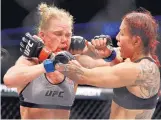 ?? JOHN LOCHER/ASSOCIATED PRESS ?? Cristiane “Cyborg” Justino, right, hits Holly Holm during their UFC 219 fight in Las Vegas, Nev. on Saturday night. Cyborg retained her featherwei­ght title with a unanimous decision.