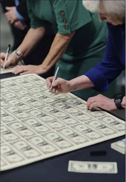  ?? ADAM PEREZ — THE NEW YORK TIMES ?? Treasury Secretary Janet Yellen signs currency at the Bureau of Engraving and Printing’s western currency facility in Fort Worth, Texas, on Thursday. Yellen, the first female treasury secretary, and Marilynn Malerba, the first Native American to hold the role of treasurer, will now have their signatures on America’s currency.