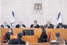  ?? ABIR SULTAN ?? A panel of 11 Israeli Supreme Court judges wearing face masks hears arguments against the legality of Prime Minister Benjamin Netanyahu’s coalition deal.