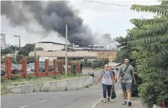  ?? NINA LYASHONOK, AP ?? People walk away from an area that was shelled by Russian forces in Odesa, Ukraine, on Saturday.