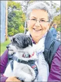  ?? KATIE SMITH/THE GUARDIAN ?? Joan Atkinson of Guernsey Cove is shown at the Pawd in the Park event on Oct. 15 at Victoria Park in Charlottet­own with her adopted dog, Pippy.