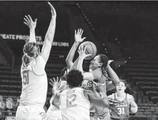  ?? Rod Aydelotte / Waco Tribune-herald ?? Texas guard Celeste Taylor, right, attempting a shot over Baylor’s Caitlin Bickle, left, helped lead the program to a seventh straight NCAA Tournament under first-year coach Vic Schaefer.