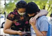  ?? JACQUELYN MARTIN — THE ASSOCIATED PRESS ?? People listen to news reports as they wait Tuesday in Washington, to hear the verdict in Minneapoli­s, in the murder trial against former Minneapoli­s police officer Derek Chauvin was announced.