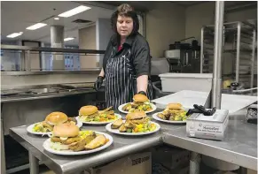  ??  ?? Janis Croxall serves up meals at the Yukon Housing Centre.