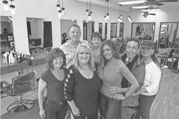  ?? PHOTOS PETER ACKERMAN/ASBURY PARK PRESS ?? Justine Talarico, owner, second from left on front row, and her long-time staff at Just Hair & Nails in Oceanport. From the left are Pam Hollander, Paul Connelly, Bunni Carroll, Geogea Scarpino, Thomas Blackburn and Linda Mihalic.