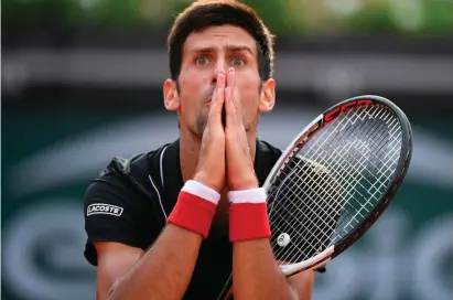  ??  ?? Novak Djokovic reacts after missing a shot against Marco Cecchinato during his French Open quarter-final defeat