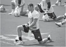  ?? AP Photo/Wilfredo Lee ?? ■ Miami Dolphins quarterbac­k Ryan Tannehill stretches during practice Wednesday at the Dolphins training facility in Davie, Fla. Tannehill returns to the Dolphins’ practice field this week for OTAs, optimistic he can stay healthy after suffering a...