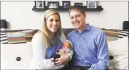  ?? Michael Cummo / Hearst Connecticu­t Media ?? Farah Hage-Sleiman and Derek Roy pose for a photo with their newborn son Lucas Henry Roy inside their Morgan St. apartment in Stamford on Tuesday.