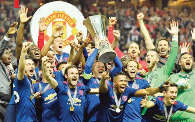  ?? — AP ?? STOCKHOLM: United's Wayne Rooney, center, lifts the trophy after winning the soccer Europa League final between Ajax Amsterdam and Manchester United at the Friends Arena in Stockholm, Sweden, yesterday..