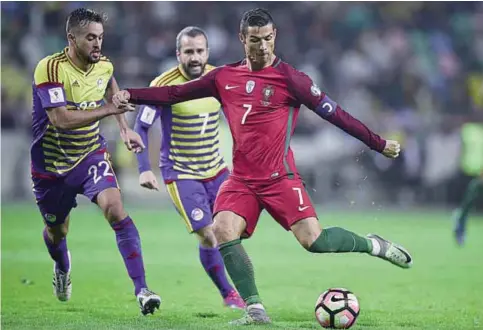  ?? —AFP ?? AVEIRO, Portugal : Portugal’s forward Cristiano Ronaldo (R) vies with Andorra’s midfielder Victor Rodriguez (L) during the WC 2018 football qualificat­ion match between Portugal and Andorra at the Municipal de Arouca stadium.