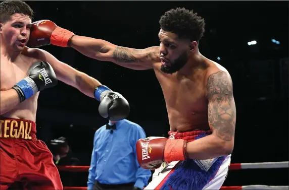  ?? PHOTO BY EMILY HARNEY ?? Kendrick Ball Jr. of Worcester lands a right hand to the head of Mike Stegall. Ball won by decision Thursday night at the Agganis Arena in Boston.