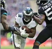  ?? MATT DUNHAM - THE ASSOCIATED PRESS ?? Eagles running back Corey Clement carries the ball during a game against Jacksonvil­le at Wembley Stadium in 2018. The Eagles signed Clement to a one-year deal Wednesday.