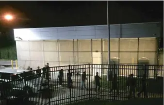  ?? JODIE BOWERS VIA AP ?? Detainees are escorted into an Immigratio­n and Customs Enforcemen­t facility Wednesday in Brooklyn Heights, Ohio. More than 100 workers were arrested Tuesday at an Ohio meatpackin­g plant.