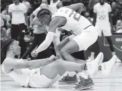  ?? NAM Y. HUH AP ?? UM’s Isaiah Wong is congratula­ted by Kameron McGusty after making a shot against Iowa State on Friday.