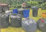  ??  ?? Genshu sorts recyclable cans and bottles at his home in Hauula.