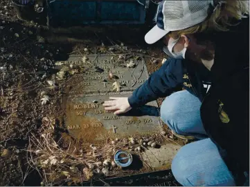  ?? PHOTOS BY LUCY LLEWELLYN BYARD FOR THE RECORD-BEE ?? Brooklyn Redford cleans a veteran’s tombstone in advance of the Wreaths across America event as part of her senior project.