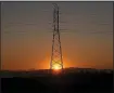  ?? KARL MONDON — BAY AREA NEWS GROUP ?? The sun rises in Larkspur behind an electrical transmissi­on tower on Oct. 9, the first day of a planned safety power outage.