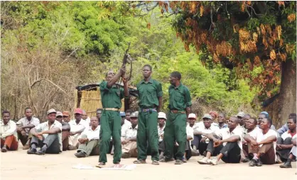  ?? — AFP ?? MAPUTO: This file photo taken on November 8, 2012 shows fighters of the former Mozambican rebel movement “Renamo” receiving military training in Gorongosa’s mountains, Mozambique.