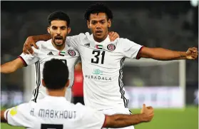  ??  ?? Romarinho, right, has egged on his teammates at Al Jazira to show their ‘strong personalit­y’ as a young team when they face heavyweigh­ts Real Madrid EPA