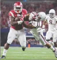  ?? NWA Democrat-Gazette/Jason Ivester ?? LONE STAR: Unrecruite­d by major schools in his native Texas, Arkansas’ Rawleigh Williams III has a built-in revenge motive for the Razorbacks’ game tonight against Texas A&M at AT&T Cowboys Stadium in Arlington. Williams is pictured fighting off a...