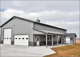  ?? ?? Behind the home is a new six-car, detached, 40-by-64-foot garage/barn with floor heating system, epoxy floor coating, 200-amp electric, 16-foot ceilings and a 14-foot oversized door.