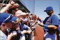  ?? Ross D. Franklin / Associated Press ?? Chicago Cubs’ Seiya Suzuki, of Japan, signs autographs for fans prior to a spring training baseball game against the Chicago White Sox on Monday in Mesa, Ariz. About 1 in 4 fans of Major League Baseball feel at least some anger toward the sport after its first work stoppage in a generation, according to a new poll, but the vast majority are still excited about the new season. Only 27% of Americans say they are currently a fan of MLB, according to the poll from The Associated Press-NORC Center for Public Affairs Research.