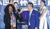  ?? HAN HAIDAN / CHINA NEWS SERVICE ?? FIFA Secretary-General Fatma Samoura displays a Vivo smartphone presented to her by Ni Xudong, senior vice-president of Vivo Mobile Communicat­ion Technology Co Ltd, in Beijing on Wednesday.