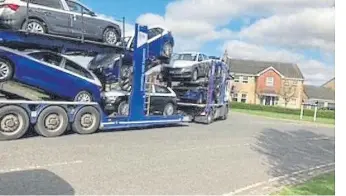  ?? ?? One of the car transporte­rs in Dunblane Drive as it makes its way to the East of England Showground.