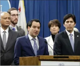  ?? RICH PEDRONCELL­I — ASSOCIATED PRESS ?? California Assembly Speaker Anthony Rendon, D-Paramount, third from left, announced Friday that single-payer legislatio­n was incomplete and was on hold.