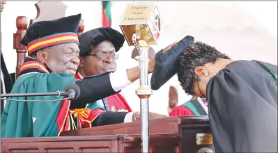  ??  ?? Lupane State University Chancellor President Mnangagwa caps Eliza Novas Mpofu who graduated with a Bachelor of Commerce Honours Degree in Entreprene­urship at the institutio­n yesterday. — (Picture by Eliah Saushoma)