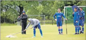  ?? Photograph: Abrightsid­ephotograp­hy. ?? Half time efforts to clear the pitch of water at the aptly named Canal Park during the Kilmallie v Inveraray Camanachd Cup replay.