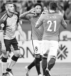  ??  ?? Urawa Reds’ Rafael Da Silva (centre) celebrates his goal with teammate Zlatan (right) beside Kawasaki Frontale’s Eduardo during the AFC Champions League quarter final match in Saitama. — AFP photo