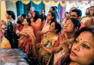  ?? ?? Devotees pray Monday before an idol of Hindu goddess Durga on the second day of Durga Puja festival.