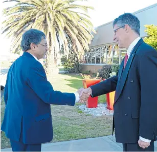  ?? Picture: SUPPLIED ?? CHANGE OF GUARD: Trade & industry minister Ebrahim Patel, left, shakes hands with Michael Sacke, the outgoing MD of Isuzu Motors SA.