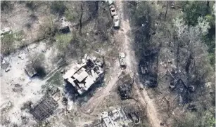  ?? (Ukrainian Airborne Forces Command/via Reuters) ?? DESTROYED BUILDINGS and burnt vehicles on the banks of Siverskyi Donets River in eastern Ukraine are seen from above.