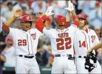  ?? Nick Wass ?? Pedro Severino (29) and Mark Reynolds greet Juan Soto after scoring on the rookie’s secondinni­ng home run Monday in the Nationals’ 10-2 home victory over the Padres.
The Associated Press