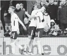  ?? RUI VIEIRA THE ASSOCIATED PRESS ?? Tottenham’s Harry Kane, right, celebrates after scoring his side’s second goal against Liverpool on Sunday. The teams played to a 2-2 tie.