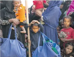  ?? MANISH SWARUP / THE ASSOCIATED PRESS ?? A Rohingya boy in a queue outside a food distributi­on centre in a refugee camp in Bangladesh.