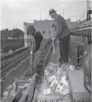  ?? Bill Young / The Chronicle 1950 ?? Janitors clean up shells after the “Peanut Revolt” forced the stadium owner to give away 18,000 bags.