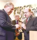  ??  ?? Left: Freddie Parris, left, receives his grandfathe­r’s Purple Heart medal from. David Lillard on Friday. The medal was found in an abandoned safe deposit box and given to the Tennessee Department of Treasury Division of Unclaimed Property. State Sen....