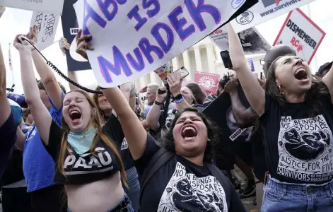  ?? Jacquelyn Martin, The Associated Press ?? Abortion opponents celebrate outside the Supreme Court on Friday in Washington. The Supreme Court has ended constituti­onal protection­s for abortion that had been in place nearly 50 years.