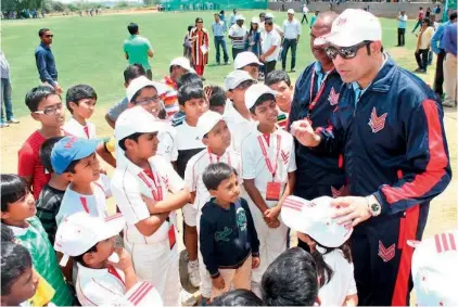  ??  ?? Former Test cricketer V.V.S. Laxman interacts with kids on the opening day of a coaching camp at the VVS Sports Academy, at Sreenidhi Internatio­nal School in Hyderabad.