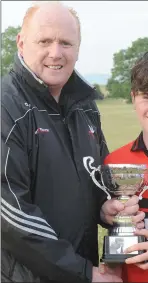  ??  ?? Kevin Gordon, Vice-Chairman, Louth Minor the Division 2B Trophy to Keelan Maher, Cap U-14 team.