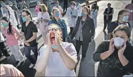  ?? Fernando Llano Associated Press ?? HEALTHCARE workers gather outside a hospital in Mexico City in April to demand protective gear and training to reduce the risk of contractin­g COVID-19.