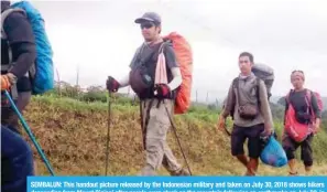  ??  ?? SEMBALUN: This handout picture released by the Indonesian military and taken on July 30, 2018 shows hikers descending from Mount Rinjani after people were stuck on the mountain following an earthquake on July 29, in Sembalun, West Nusa Tenggara. — AFP